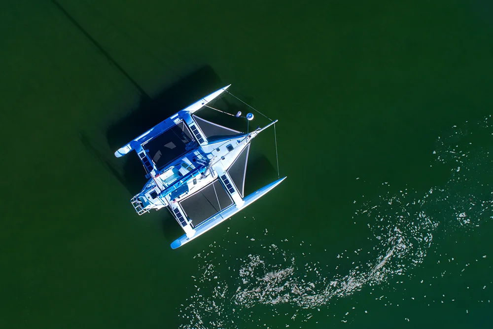 An overhead view of a sailboard at anchor.