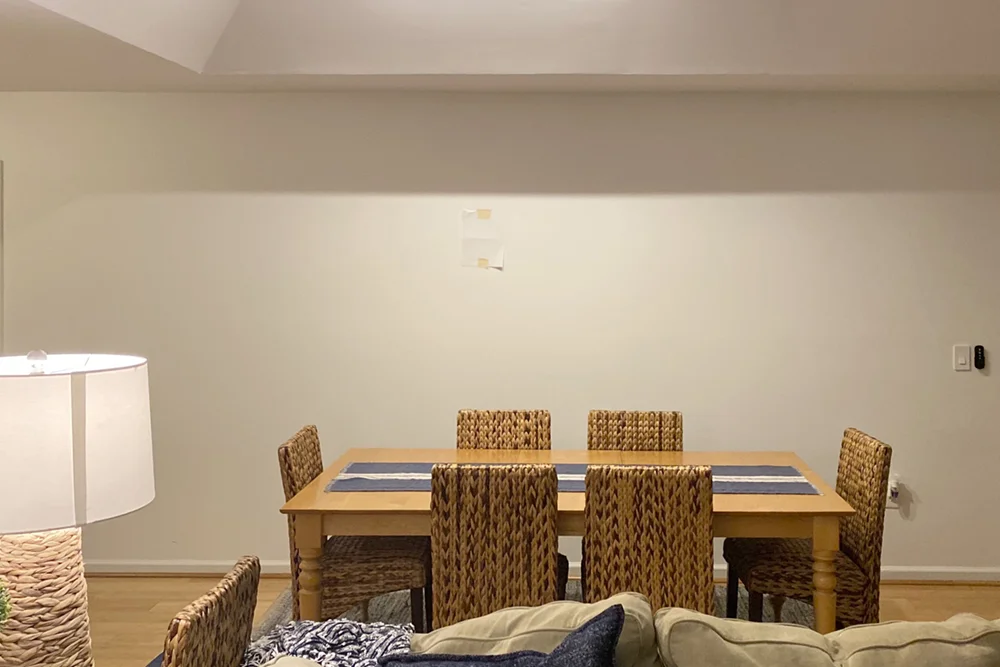Picture of a dining room table with a blank wall behind it.