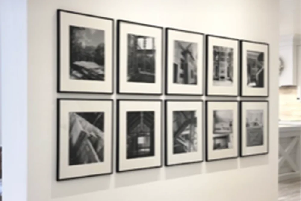 Ten black and white pictures in frames with mats displayed in two rows of 5 pictures in each row. 