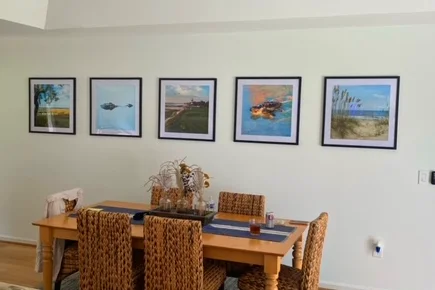 A finished installation of five picice of custom fine art photography displayed on a dining room wall.