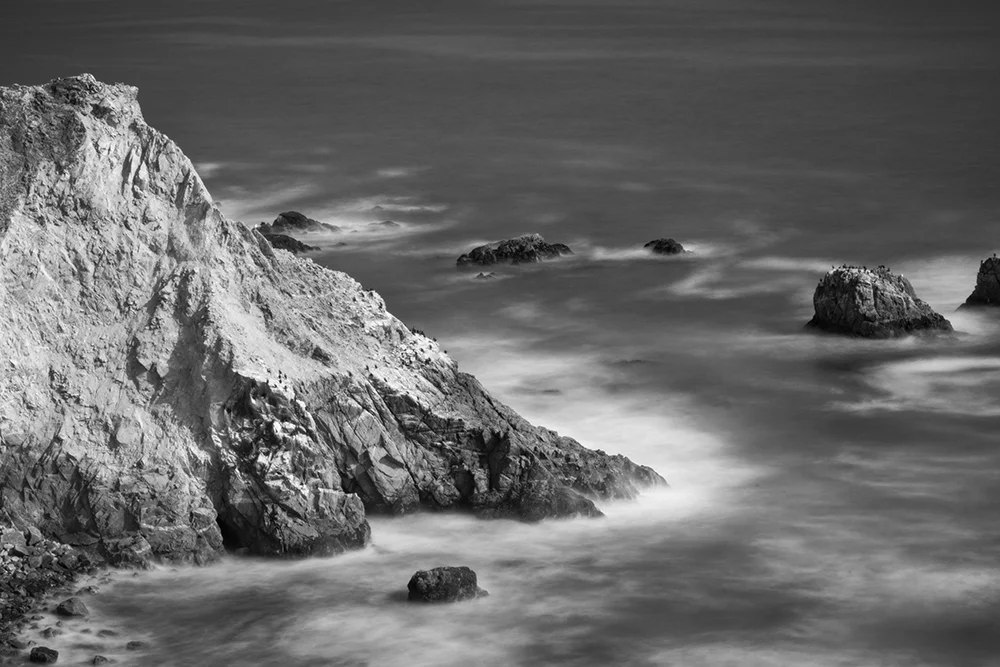 Pacific Ocean coastline long exposure image with blurred waves.